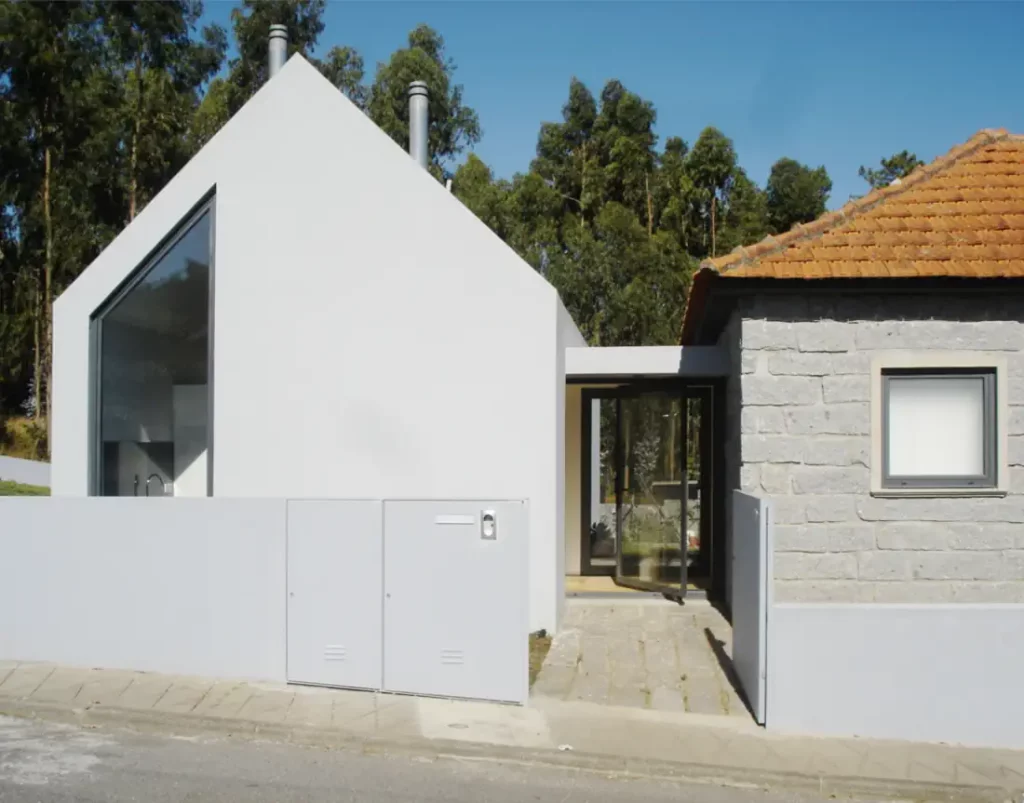 Entrance to new modern enlargement and the old house renovated