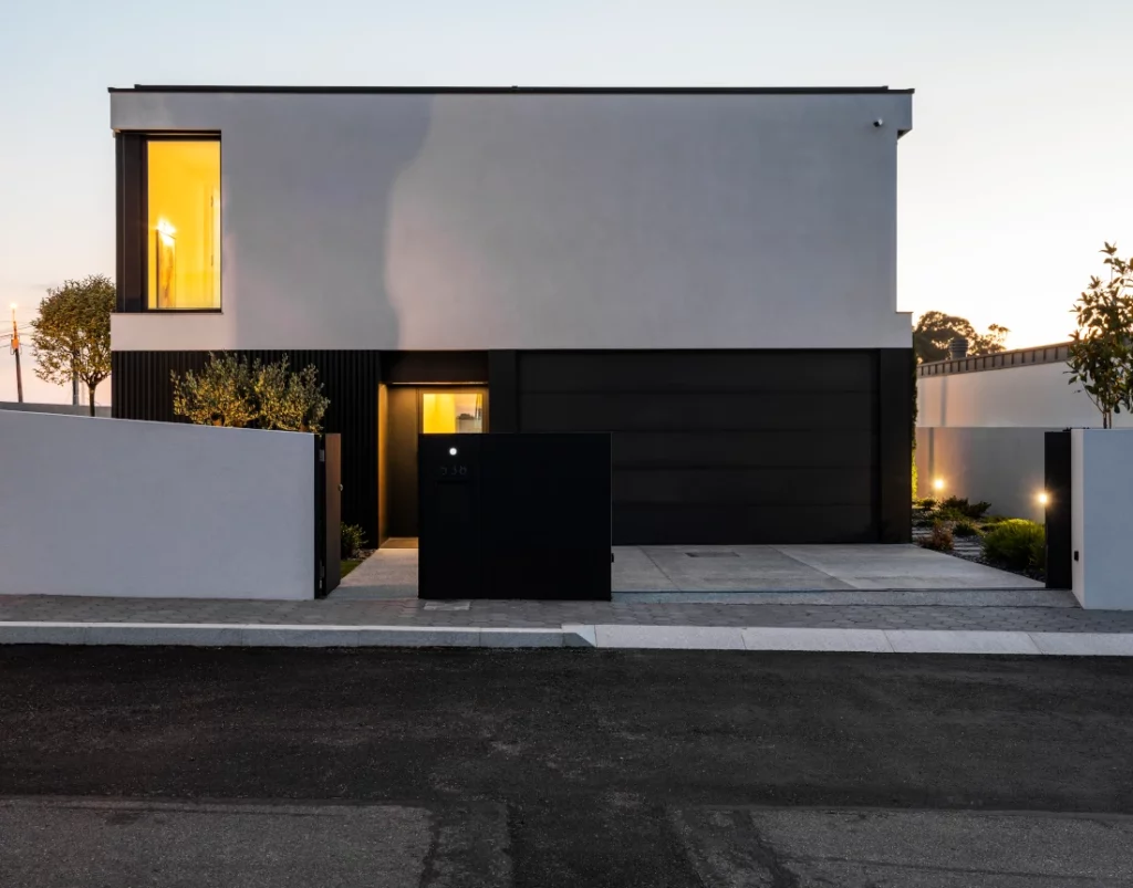 Entrance and street facade of the house with pool