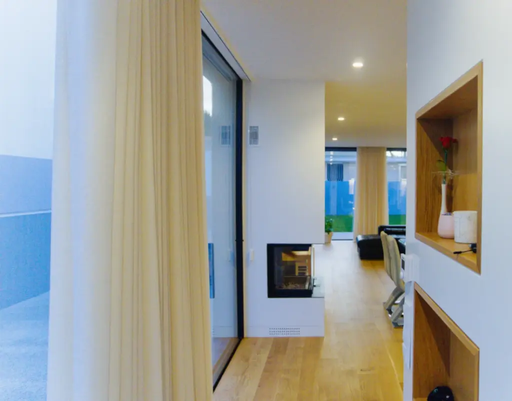 Entrance hall with built-in cupboards set into a wooden recess and a side window.