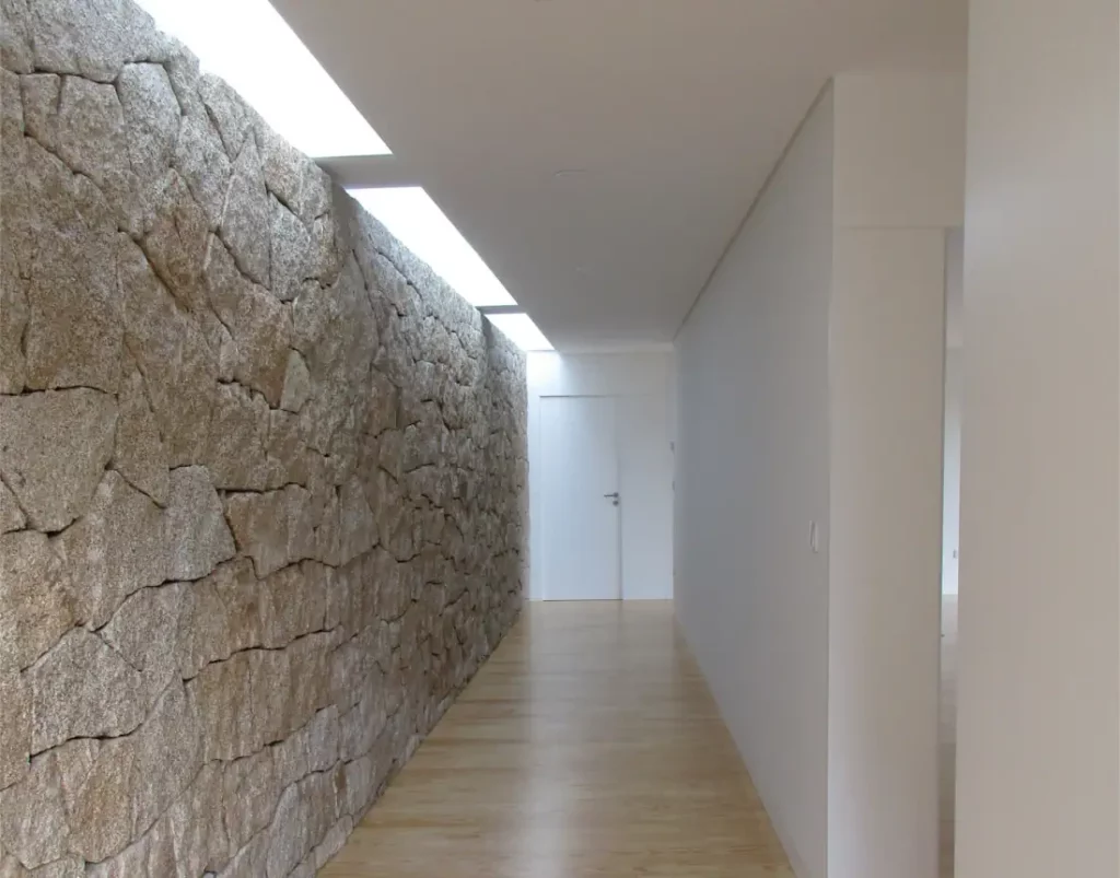 Natural stone wall and natural light on the house corridor
