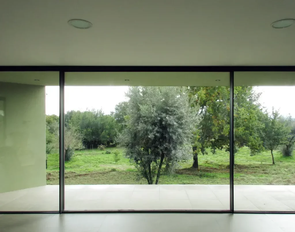 The living room has large windows to the landscape